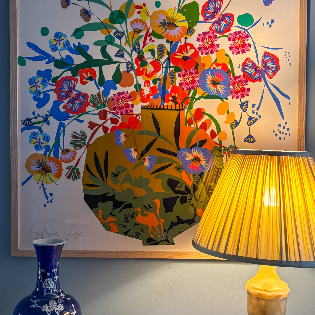 colourful vase next to blue vase and lamp