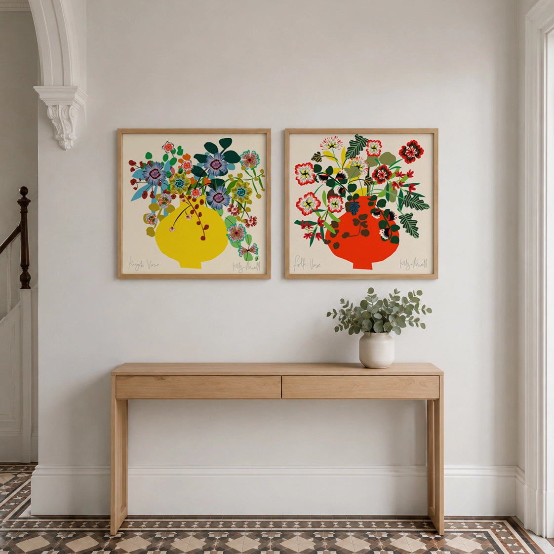 Kyoto Vase and Folk Vase fine art prints by Kitty McCall in natural oak frames above a console table in a bright hallway