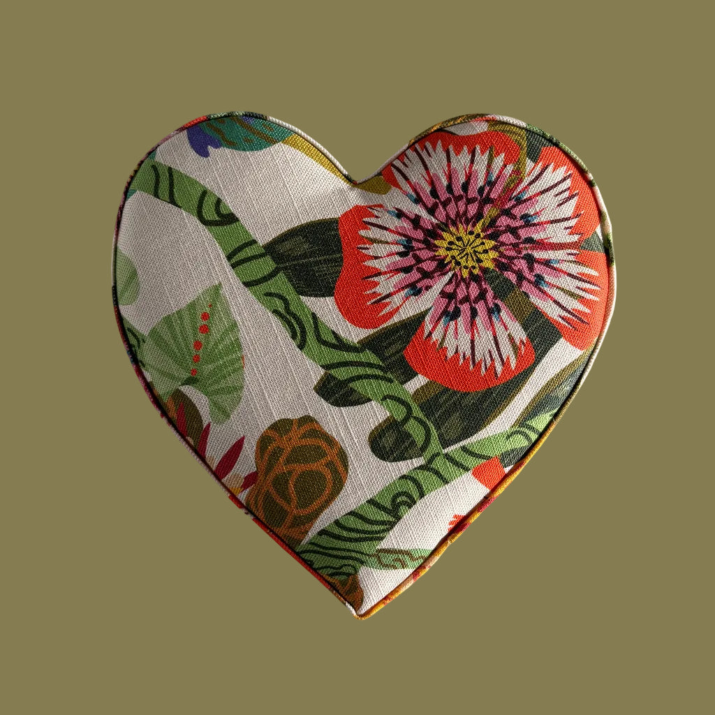 Heart-shaped fabric patch with floral design on a solid background