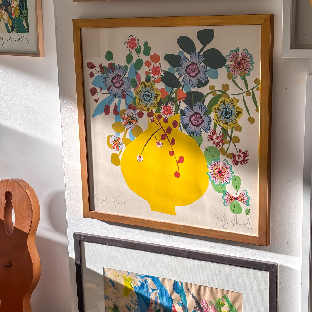 yellow vase with blooming flowers