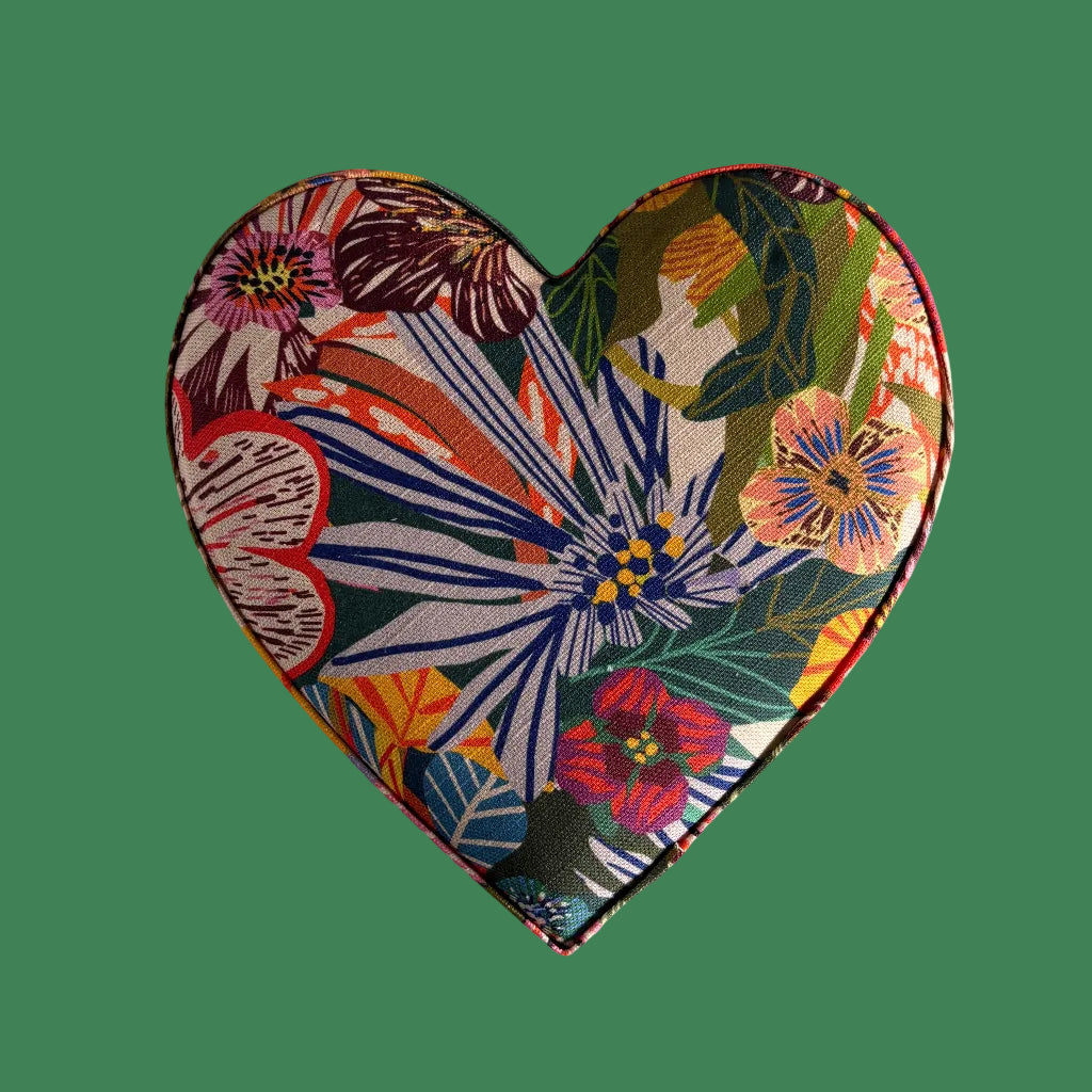 Heart-shaped fabric pouch with colorful floral pattern on a white background