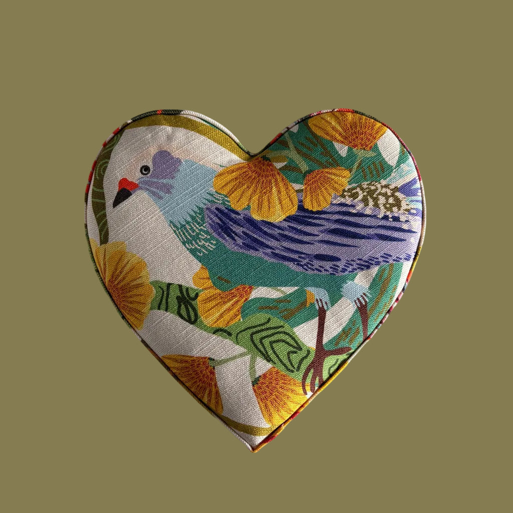 Heart-shaped fabric pouch with bird design on a light gray background
