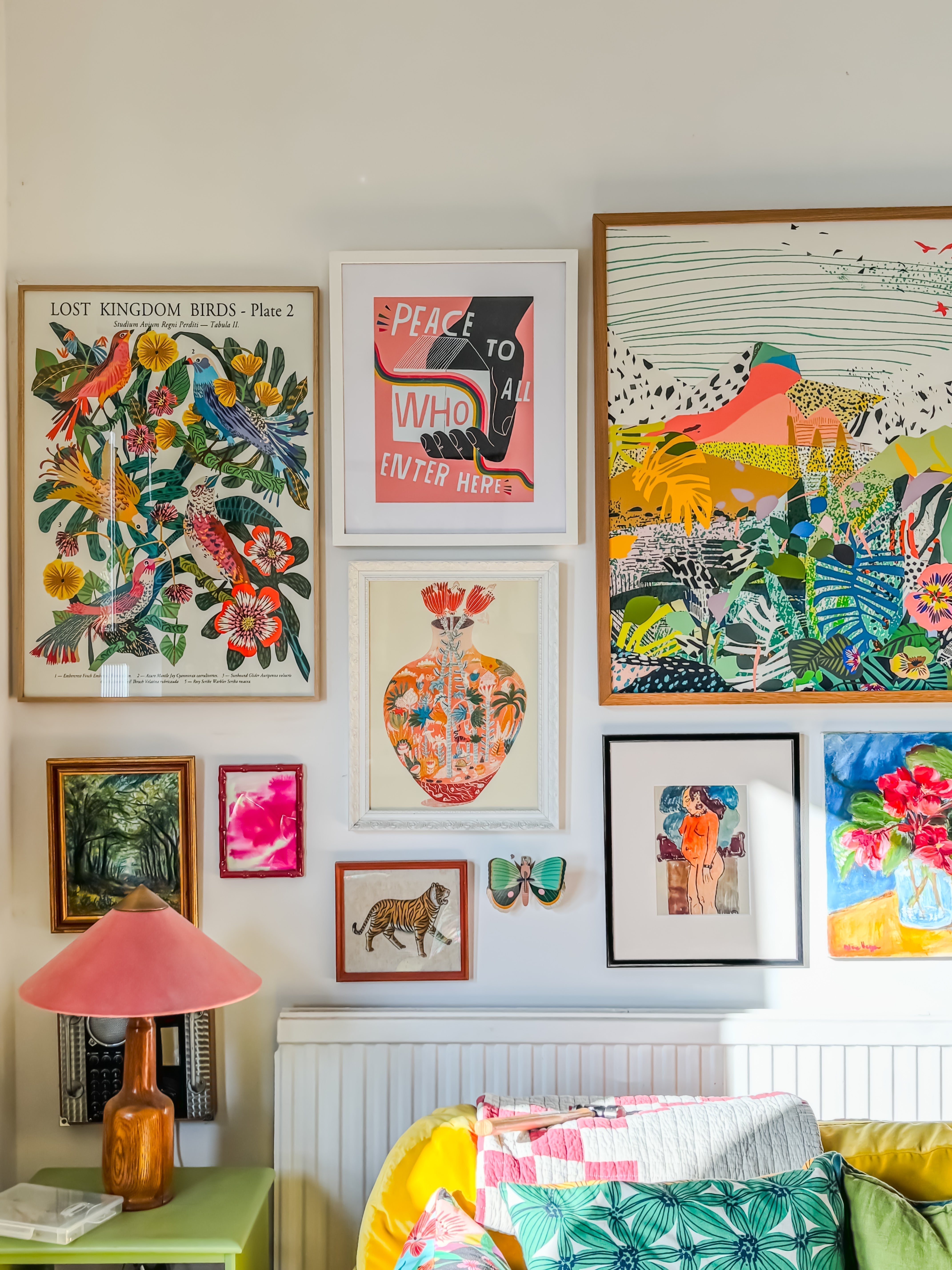 colourful living room gallery wall with botanical art prints including Flowers of Utopia