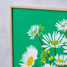 Close-up detail of the Daisy Vase fine art print by Kitty McCall showing white daisy blooms and yellow bud clusters on an emerald green background