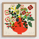 Framed artwork of a colorful floral arrangement in a red vase on a beige background