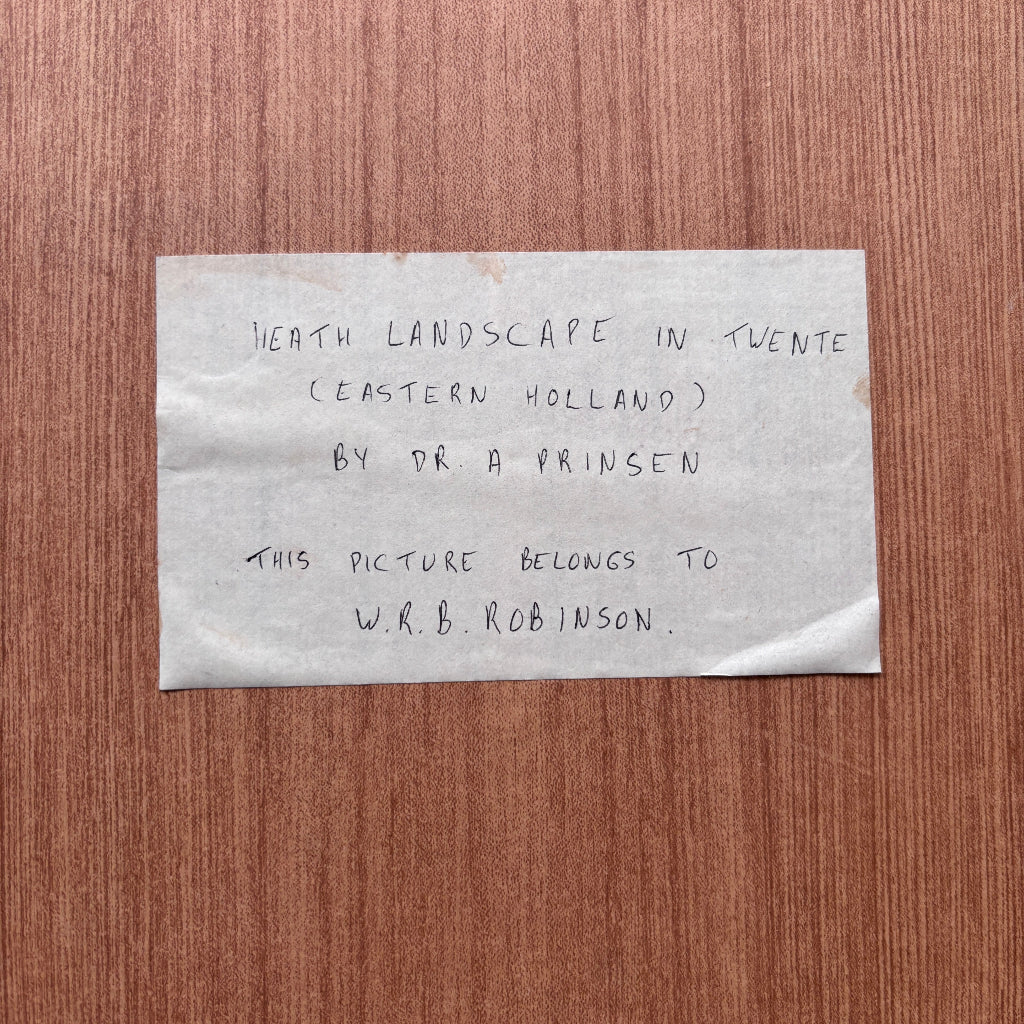 Note on a wooden surface with text about a landscape photograph by Dr. A. Prinsen.