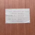 Note on a wooden surface with text about a landscape photograph by Dr. A. Prinsen.