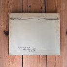 White sheet of paper with text on a wooden surface