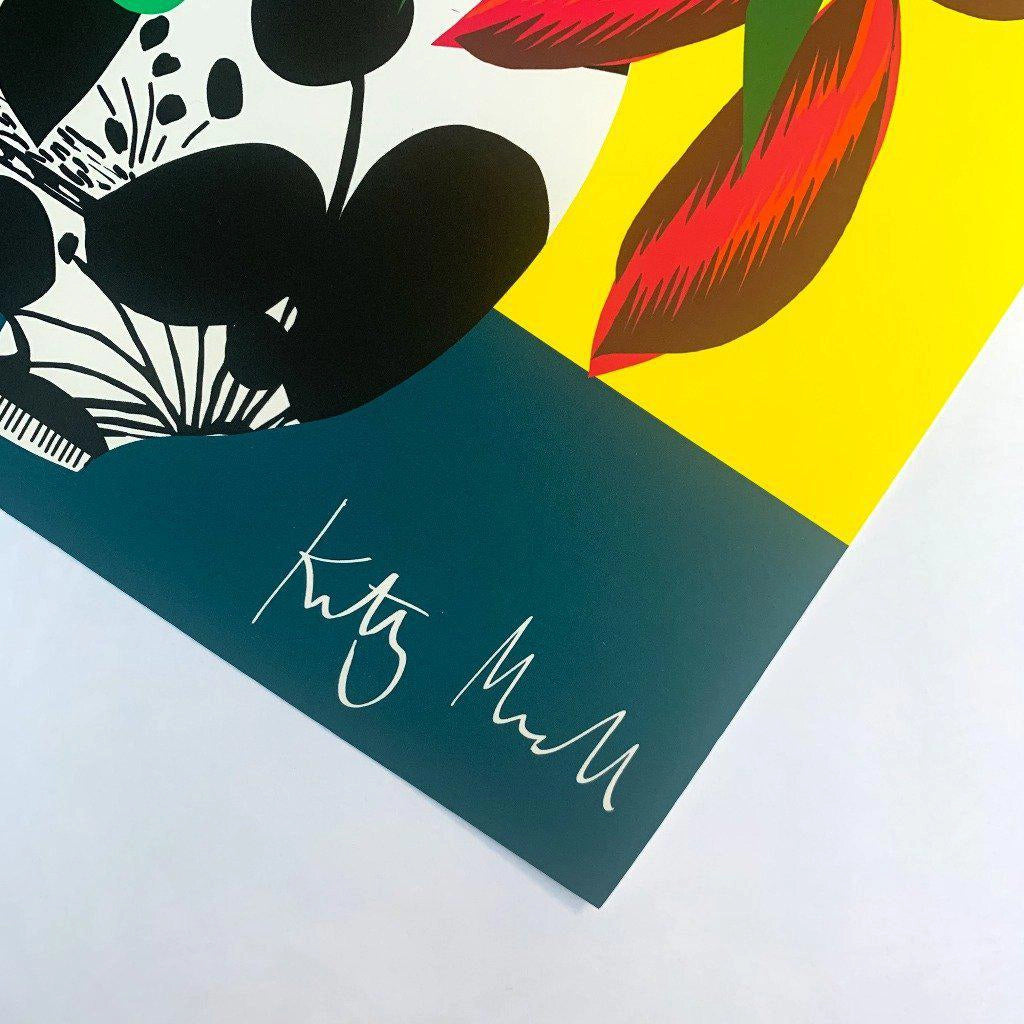 Close-up detail of the Pilea Vase fine art print by Kitty McCall showing the artist's signature on the teal base with graphic vase pattern