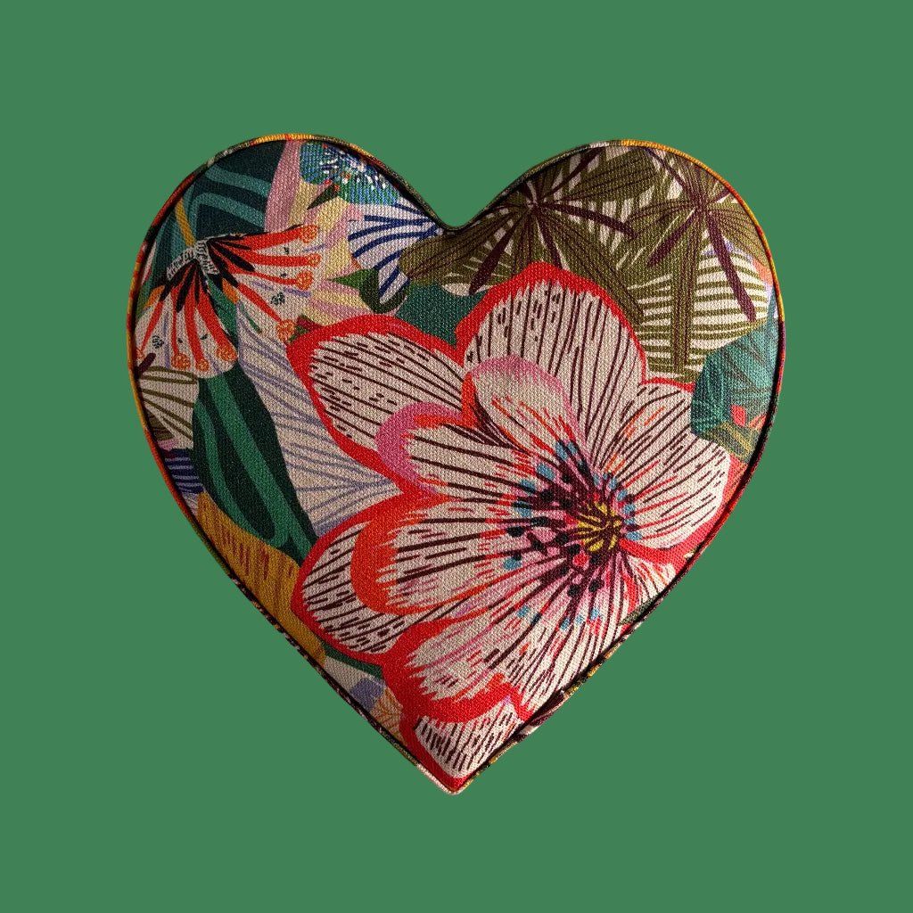Heart-shaped patch with floral design on a green background