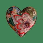 Heart-shaped patch with floral design on a green background