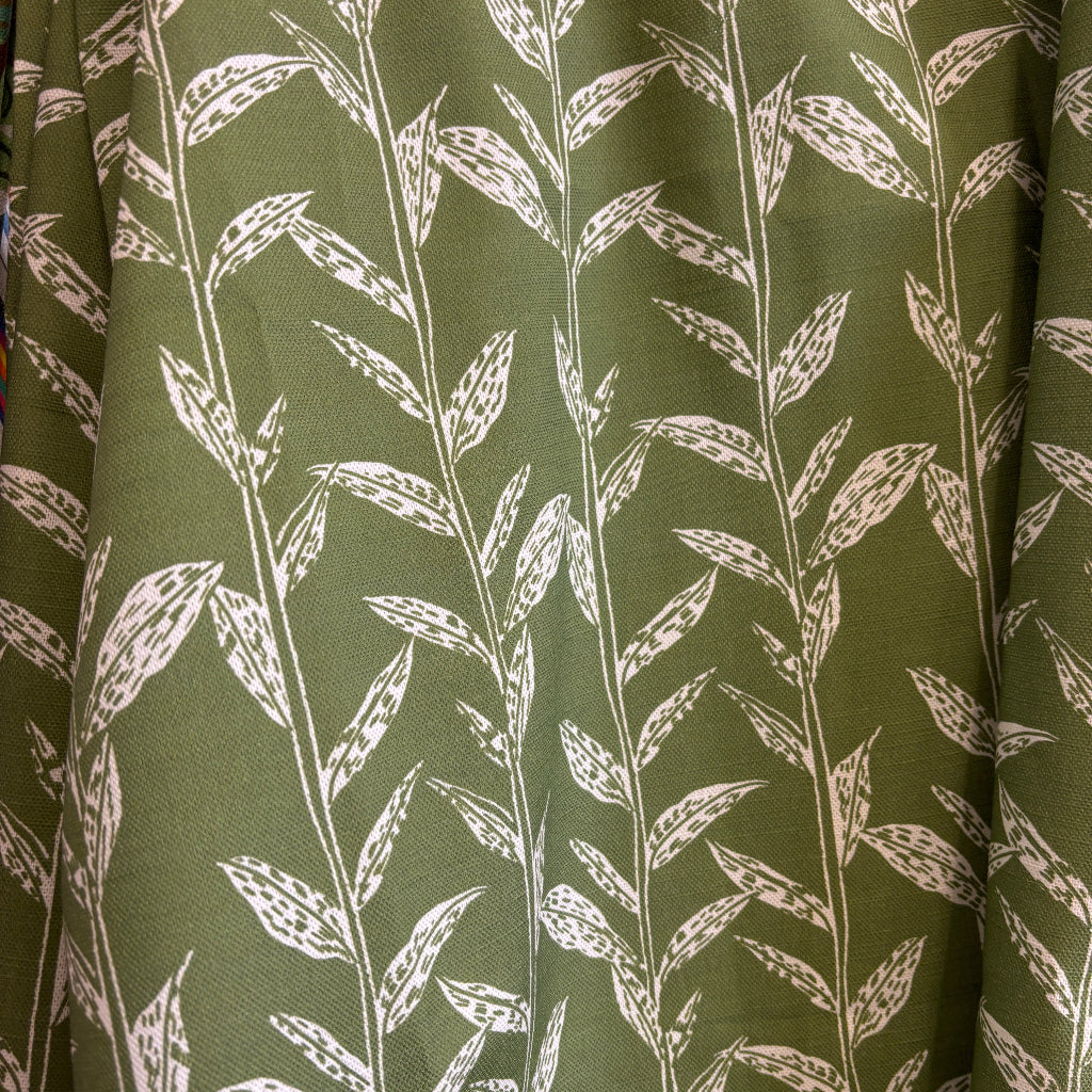 Green fabric with white leaf pattern