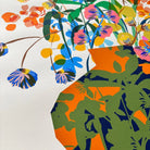 Close-up detail of the Utopia Vase fine art print by Kitty McCall showing the layered botanical blooms and bold orange-and-navy vase