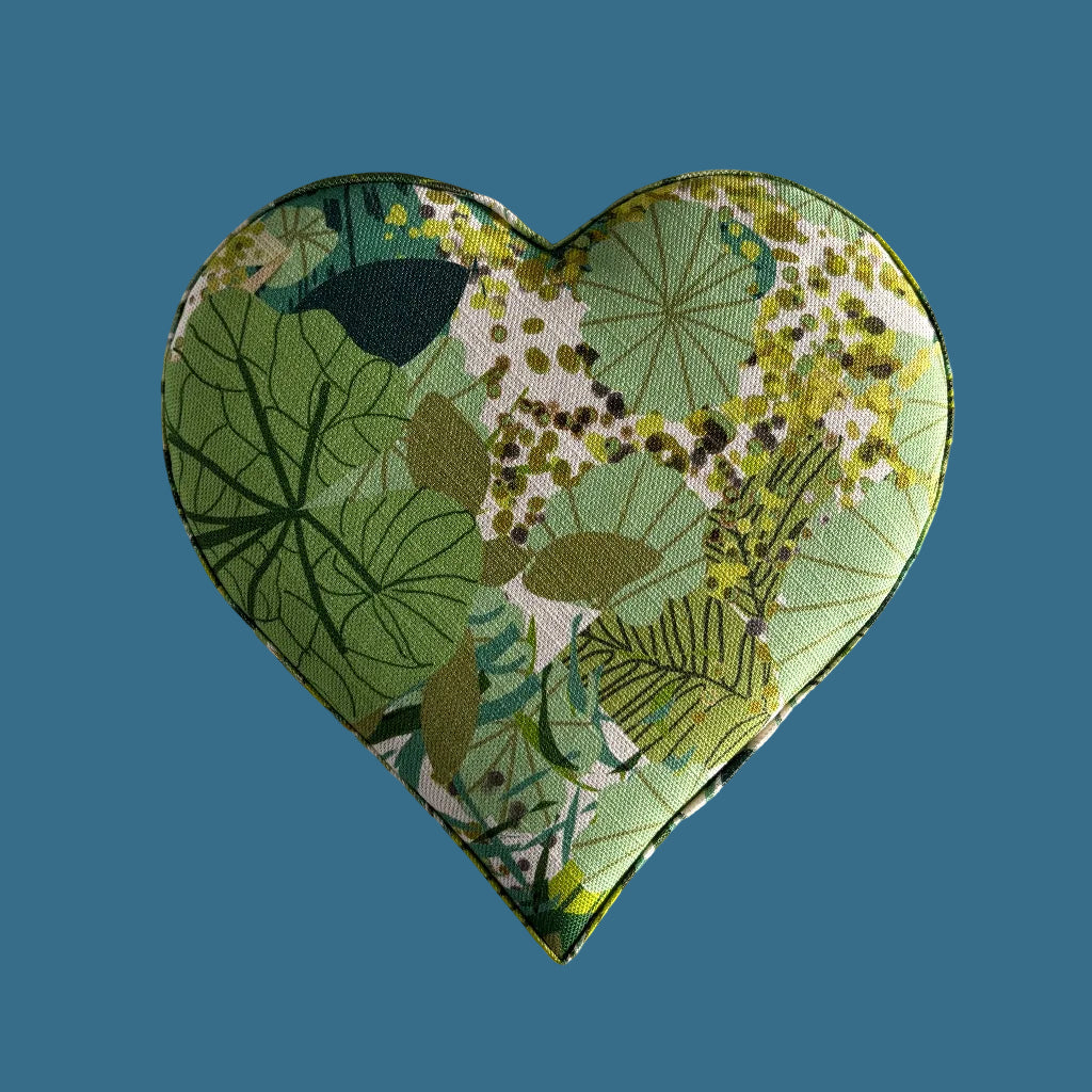 Heart-shaped fabric heart with green leaf pattern on a gray background