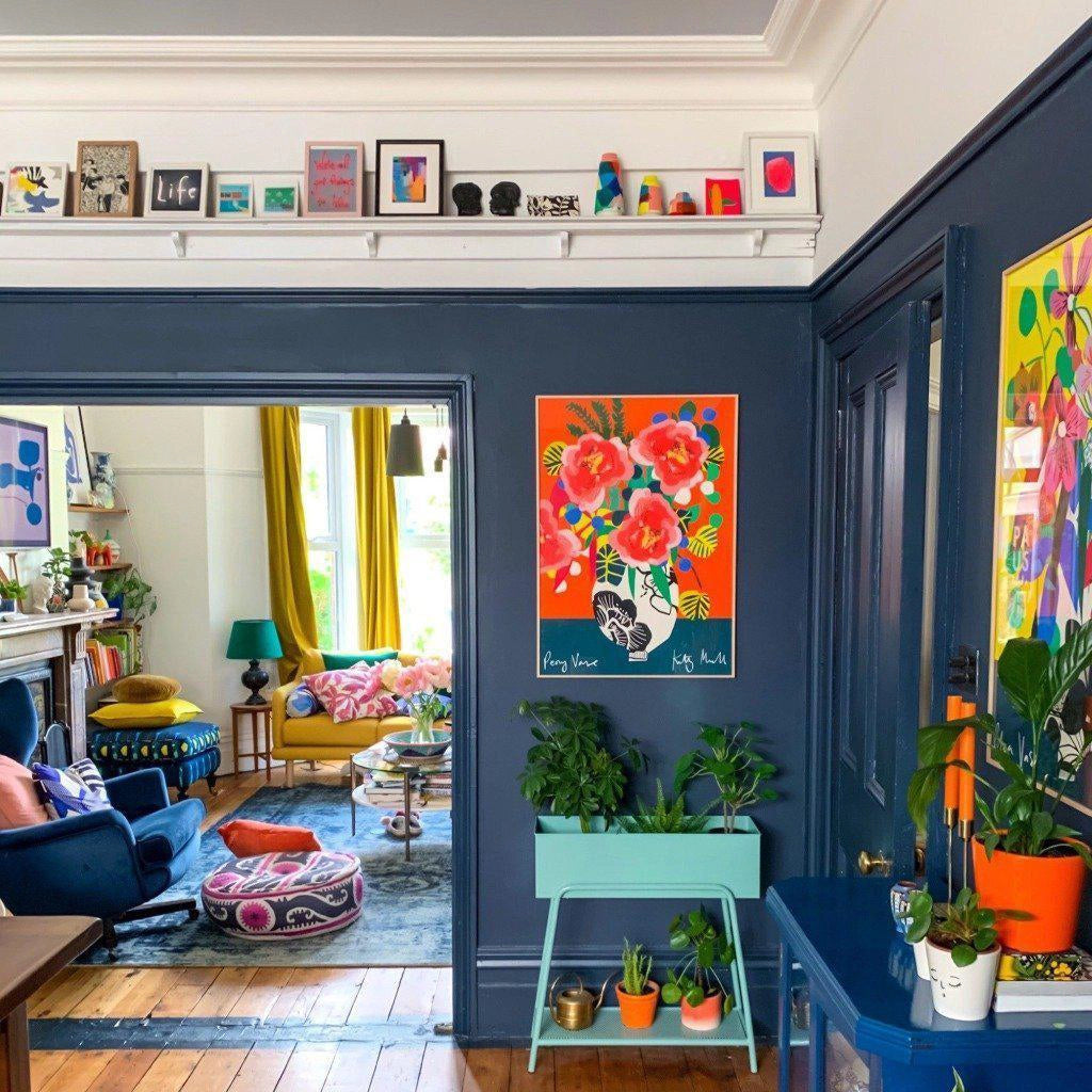 Peony Vase fine art print by Kitty McCall displayed on a dark blue wall in a colourful maximalist living room